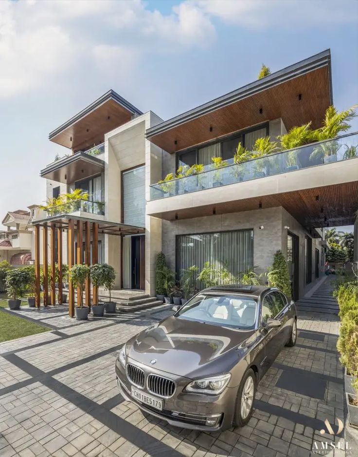 Contemporary residence with planted terraces, timber-clad soffits and a pergola walkway